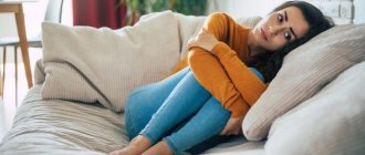 Sad woman in deep depression sitting on sofa, crying