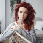 Very attractive young woman indoors. portrait of a curly girl 